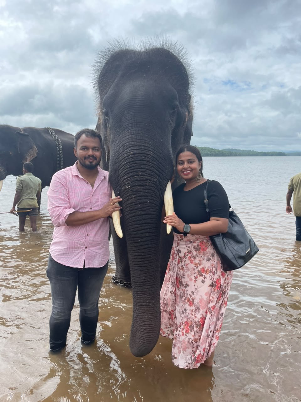 Pradeep and Ananya with an elephant by the water