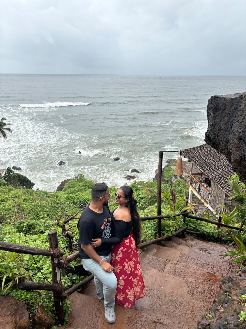 Pradeep and Ananya on a stairway above the sea