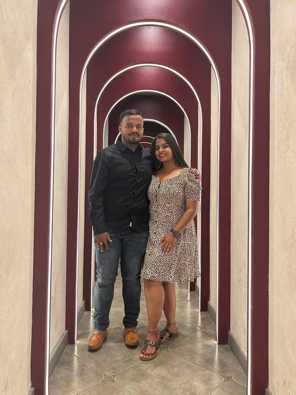 Pradeep and Ananya under maroon arches